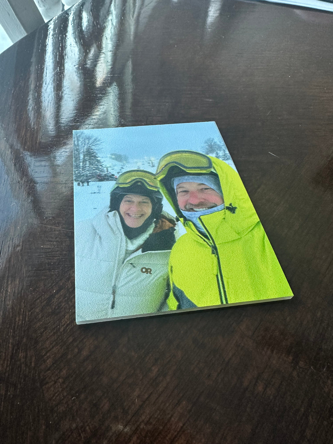 High-resolution full-color UV printing on clear acrylic showing a detailed photograph of a couple skiing, demonstrating Silver Lining Engraving’s custom color printing capabilities in West Michigan.